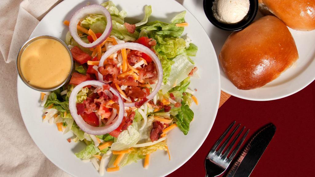 House Salad · Mixed Greens, Tomatoes, Jack and Cheddar Cheese, Bacon and Red Onion served with your choice of dressing.