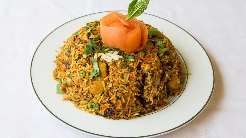 Chicken Biryani · Basmati rice favored with sa-ron, cooked with mil spiced chicken in an aromatic combination spices and nuts.