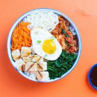 Bibimbap Tofu Bowl · Our bibimbap bowl filled with tofu, fermented kimchi, spicy gochujang, a fried egg and toppe...