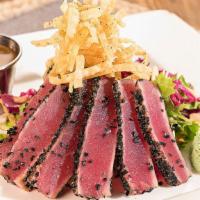 Seared Ahi Tuna · Sashimi grade tuna rolled in sesame seeds and seared rare, served atop tangy crunch slaw wit...