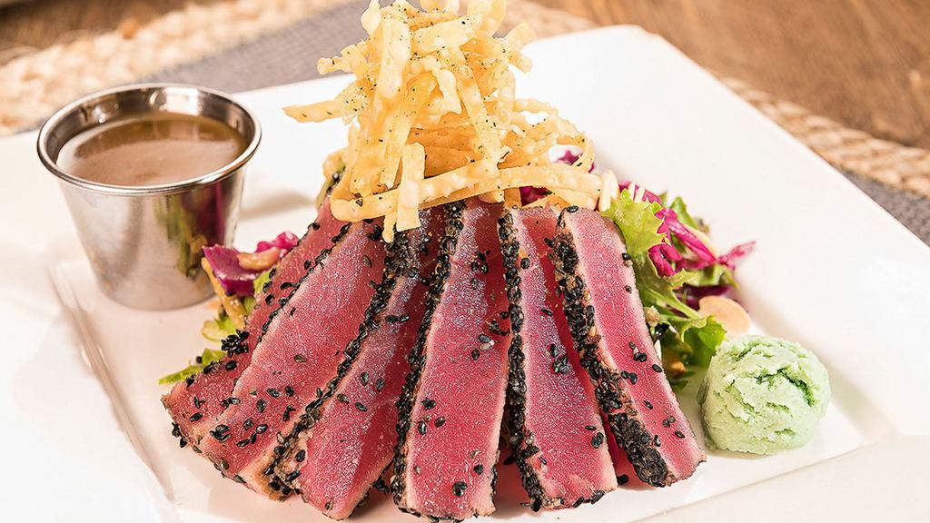 Seared Ahi · Cool Hand Luke's favorite: Sashimi grade tuna rolled in black sesame seeds and seared rare, atop tangy crunch slaw with wasabi.