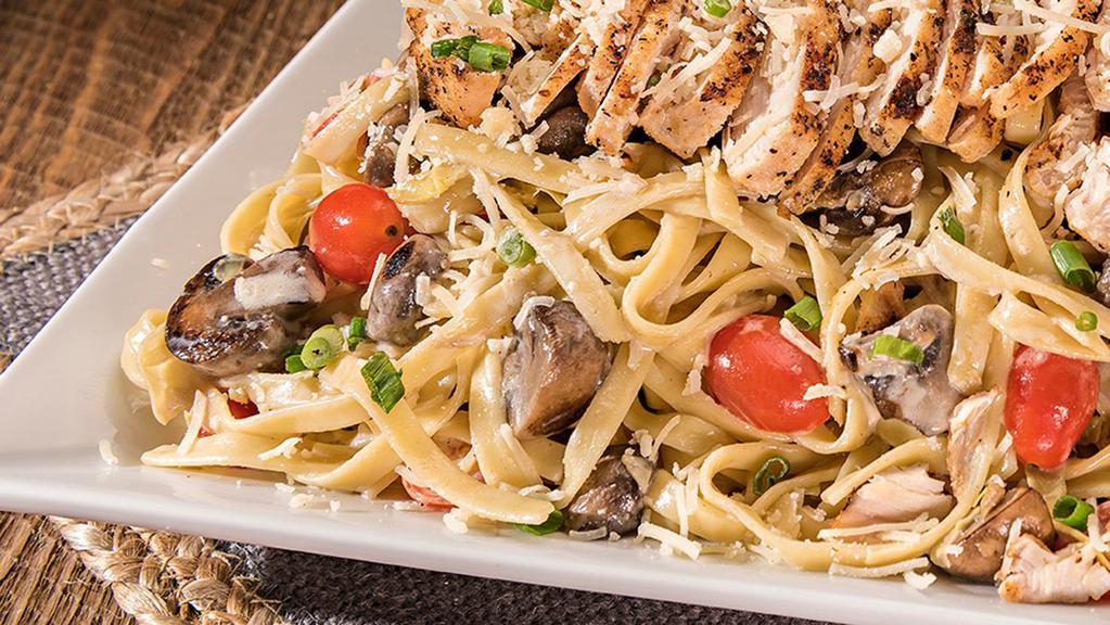 Fs Tombstone Chicken Pasta · Creamy parmesan sauce tossed with baby-Bella mushrooms, artichoke hearts, tomatoes & green onions with a hint of garlic over fettuccine topped with grilled chicken.