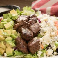 Steakhouse Cobb Salad · Tender steak, crumbled Bleu cheese, crisp bacon, fresh avocado, and diced tomatoes over mixe...