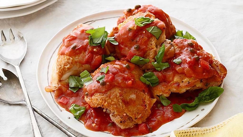 Chicken Cacciatore · Chicken cooked in a white wine sauce with roasted peppers and onions.