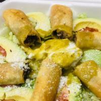 Taquitos · Six rolled corn taquitos filled with chicken, beef or pork. Served on a beans, lettuce, avoc...