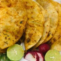 Tacos A La Plaza · Four corn tortillas, fresh from the grill, filled with chicken, beef, or carnitas, with onio...