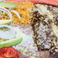 Enchiladas De Mole · Two corn enchiladas filled with chicken, beef, pork, or cheese, covered in a dark traditiona...
