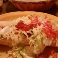 Rollos Especial · Two rolled and deep-fried flour tortillas filled with chicken, beef, or pork. Topped with gu...