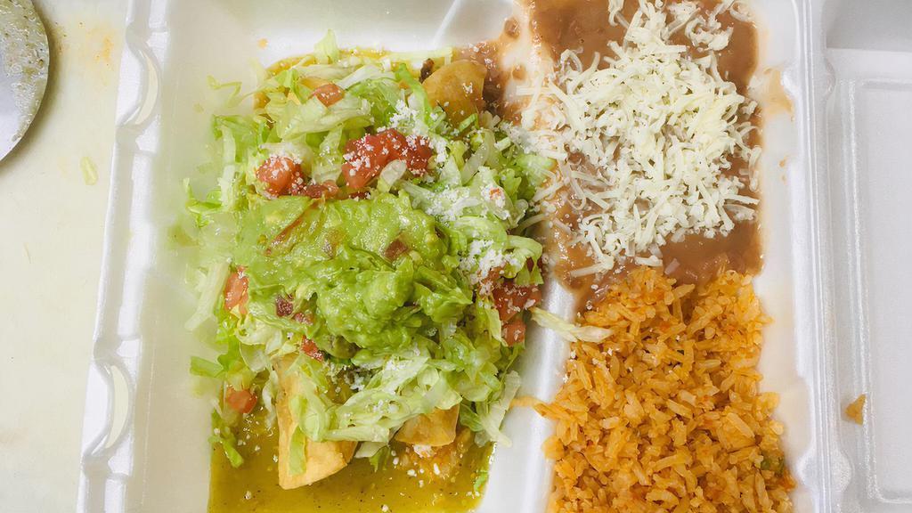 Taquitos A La Crema · Two rolled and deep-fried corn tortillas filled with chicken, beef, or pork and topped with sour cream, lettuce, tomatoes, Mexican cheese, guacamole, and green sauce. Served with rice and beans.