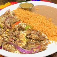 Machaca · Tender shredded beef, grilled onion, bell pepper and egg scramble. Choose rice and beans or ...