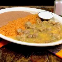 Huevos Verdes · Tender pieces of pork in traditional green sauce over two eggs and sour cream on the side. C...