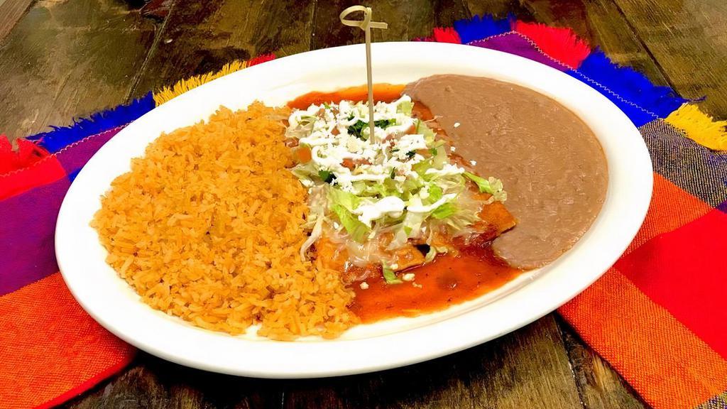 2 Enchiladas Plate · Red or green enchiladas with shredded cheese on top. Choice of shredded chicken, shredded beef, grilled veggies, asada or shrimp. Rice and beans on the side.