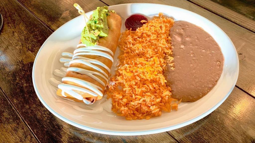 Chimichanga · Choice of shredded chicken, shredded beef or asada. Rice, beans, sour cream and cheese inside. Guacamole and sour cream drizzle on top. Rice and beans on the side.
