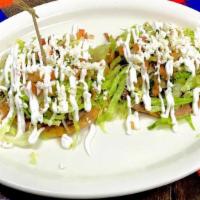 2 Tostadas Village · Crunchy tostadas include your favorite choice of meat, a thin layer of refried beans, lettuc...