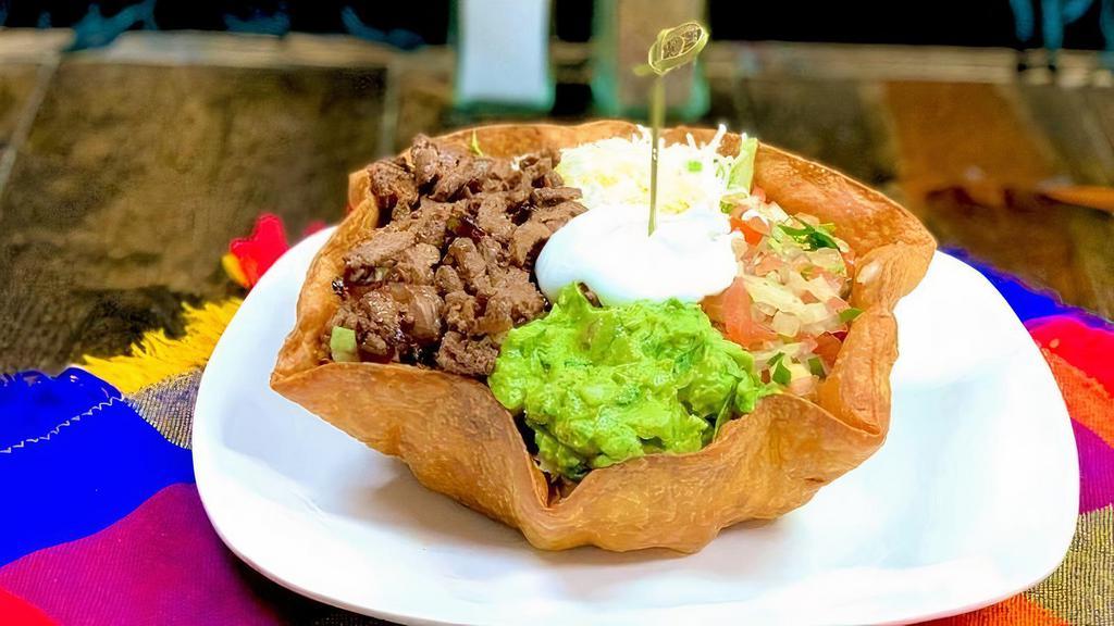Taco Salad Bowl · Flour tortilla crunchy style taco salad bowl. Choose asada pastor, shredded chicken or shredded beef. Includes, layer of beans, lettuce, guacamole, pico de gallo, sour cream and cheese.