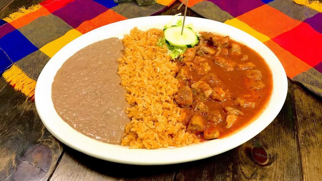 Chile Colorado · Tender pieces of pork in traditional spicy red sauce. Plate includes rice, beans and choice of tortillas.
