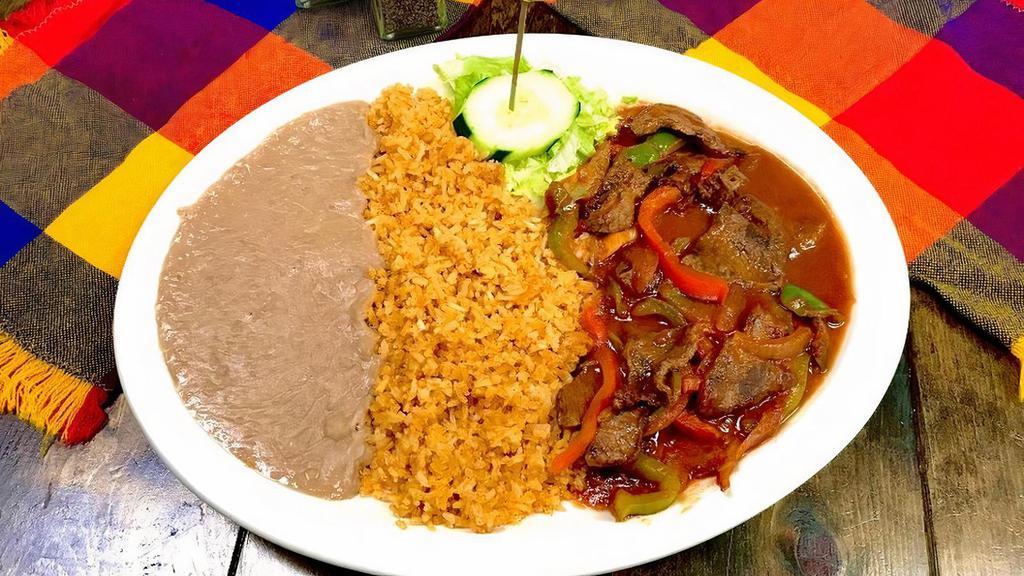 Bistek Ranchero · Thin cut pieces of grilled asada steak mixed with onions and bell pepper in housemade tomato sauce. Plate includes rice, beans and choice of tortillas.