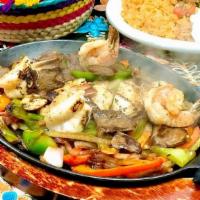 Mixto Fajitas · Combination of grilled chicken, asada steak and grilled shrimp in a mix of grilled onions, b...