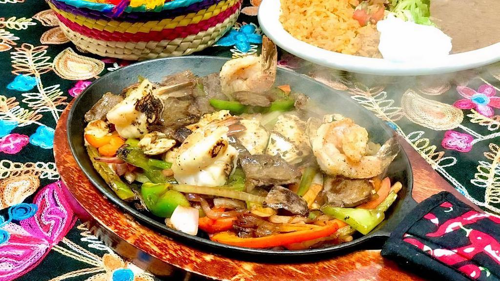 Mixto Fajitas · Combination of grilled chicken, asada steak and grilled shrimp in a mix of grilled onions, bell peppers and shredded cheese. Served with rice, beans, guacamole and sour cream on the side. Choice of tortillas.