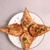 Garlic Toast · Toasted until crispy, topped with fresh butter and garlic spread.