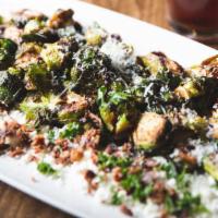 Crispy Brussels Sprouts · Beer-brined bacon, crumbled feta, balsamic reduction, and fresh grated pecorino-romano.