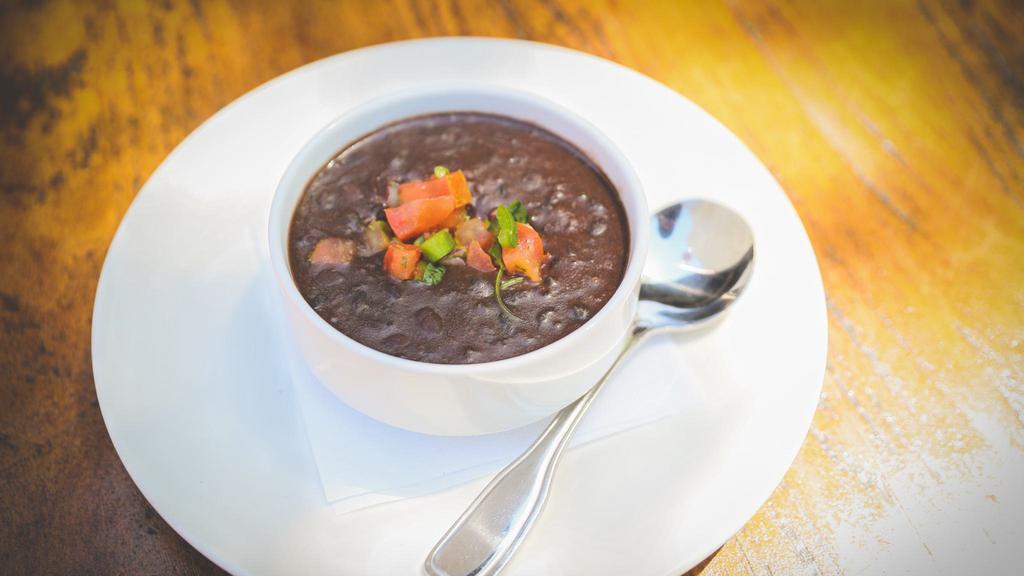 Black Bean Soup  · A cup, topped with pico de gallo.