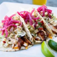 Grilled Chicken Tacos · Mesquite chicken, corn-piquillo relish, pickled onions, shredded cabbage, guajillo salsa, ch...