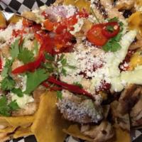 Rally Nachos · Freshly made corn tortilla chips, red onion, black beans, roasted
red peppers, garnished wit...