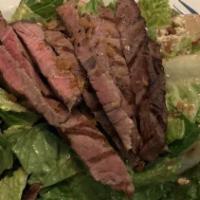 Steak Salad · Marinated steak over romaine lettuce, cherry tomatoes,
radishes, crumbled blue cheese, tosse...