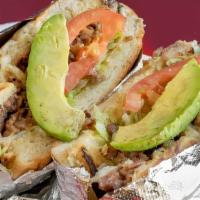 Torta · Refried beans, the meat of choice, lettuce, tomato, and avocado on a fresh Mexican telera ro...