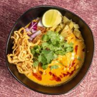 Khao Soi · Spicy. Northern Thai coconut curry noodle soup. Served with pickled mustard greens, shallots...