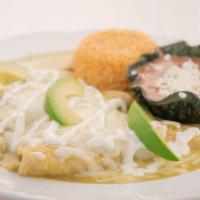 Enchiladas Suizas · Three enchiladas stuffed with chicken and cheese, topped with a creamy green sauce, sour cre...