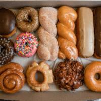 A Regular Assorted Dozen · There will be a variety of 12 donuts in the dozen. Normally are: 
4 long raised donuts (choc...