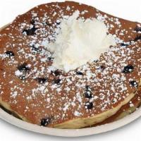 Blueberry Pancakes · Three Classic buttermilk pancakes made with fresh 
blueberries, powdered sugar, whipped butt...