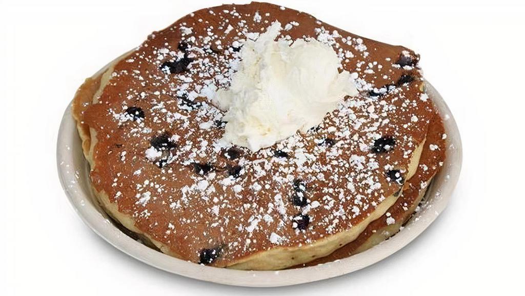Blueberry Pancakes · Three Classic buttermilk pancakes made with fresh 
blueberries, powdered sugar, whipped butter & 
classic maple syrup
