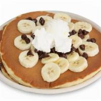 Banana Chocolate Chip Pancakes · Three Classic buttermilk pancakes made with chocolate 
chip and topped with fresh sliced ban...
