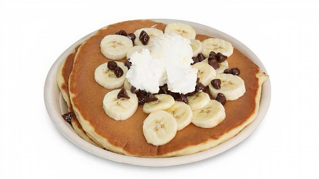 Banana Chocolate Chip Pancakes · Three Classic buttermilk pancakes made with chocolate 
chip and topped with fresh sliced banana, chocolate 
chip, whipped butter & classic maple syrup