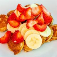 Mini Pancakes · 15 mini pancakes. Topped with diced bananas, strawberries, Nutella and lechera (condensed mi...