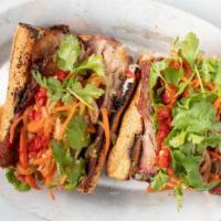 Smoked Brisket Banh Mi · Baguette, smoked brisket, pickled daikon-carrot-cucumber, cilantro, chili dressing, mayo