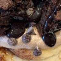 Death By Chocolate · Chocolate frosting topped with brownie bites, chocolate chips, and chocolate sauce.