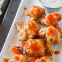 Hot Wings · Spicy. Crispy battered cauliflower covered with Buffalo sauce and served with homemade vegan...