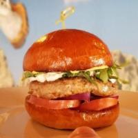 Lamb Burger · topped with a homemade tzatziki sauce, mixed greens, tomatoes & onion