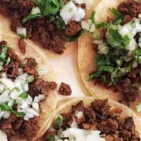 Tacos · Corn tortillas with choice of meat, cilantro, and onions.