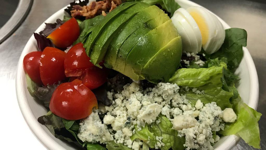 Cobb Salad · Apple-wood bacon, smoked blue cheese, heirloom tomato, hard-cooked egg, avocado, mixed greens, and blue cheese dressing.