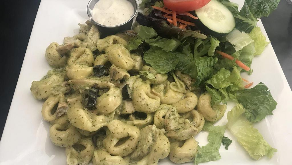 Al Pesto Tortelloni · Cheese-filled tortelloni, grilled chicken, olives and tomatoes in a rich, creamy pesto sauce.