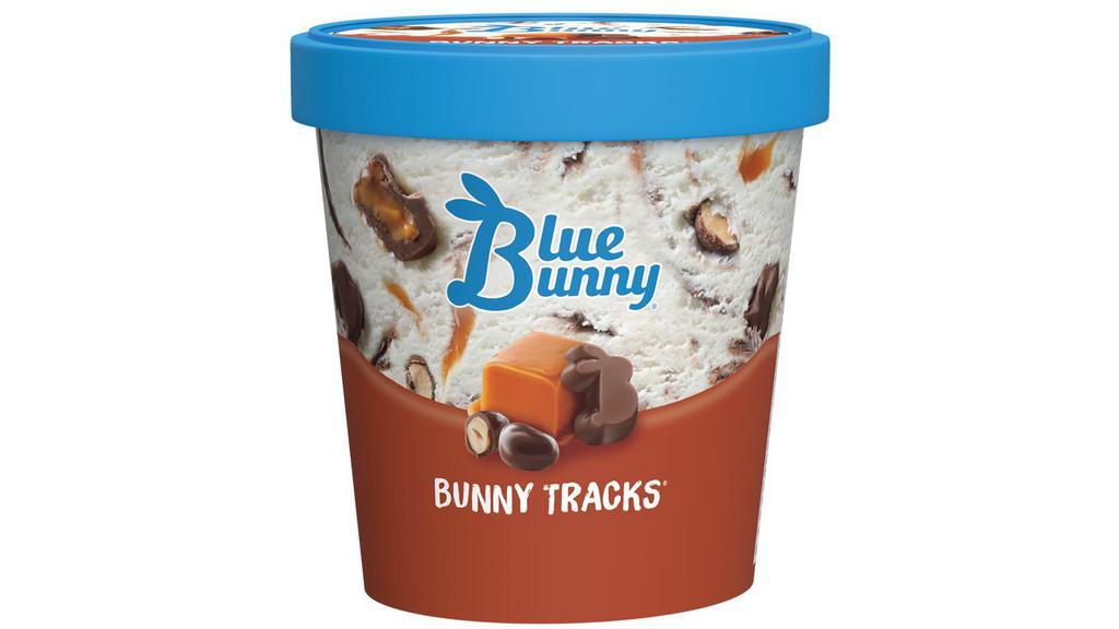 Blue Bunny Bunny Tracks · 14 oz. Vanilla with chocolate peanut butter bunnies, chocolate covered peanuts, caramel and fudge swirls.