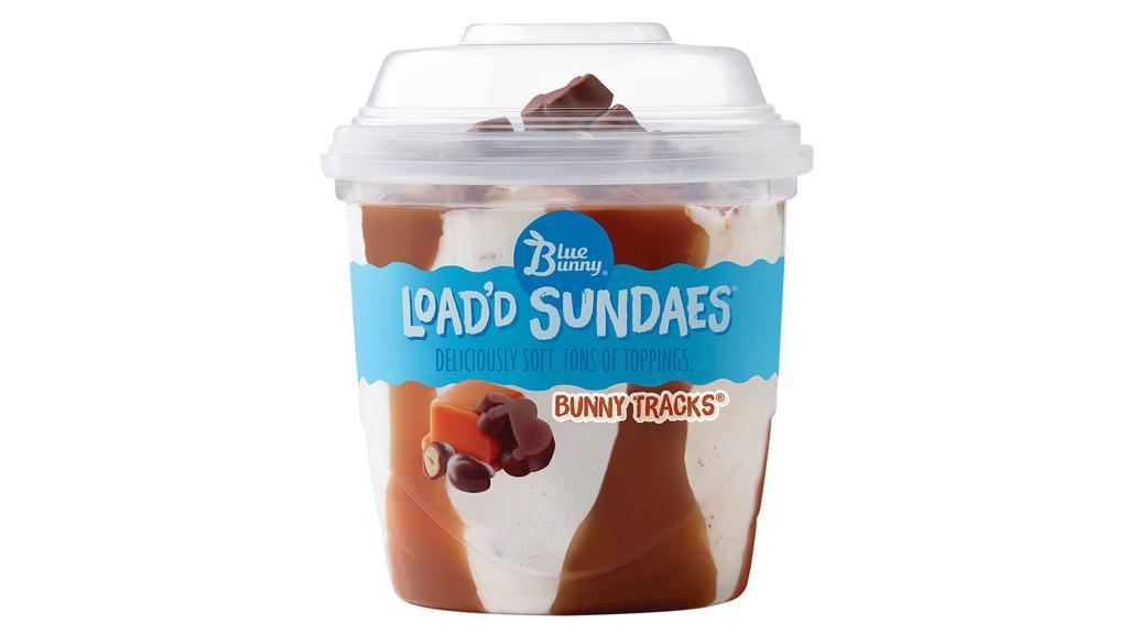 Blue Bunny Bunny Tracks Load'D Sundae · 8.5 fl oz. Soft vanilla frozen dairy dessert perfectly blended with caramel and fudge swirls, with chocolaty covered peanuts and chocolaty peanut butter bunnies.