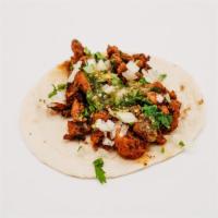 Al Pastor Taco · Marinated Pork, Cilantro, onions, and salsa verde.