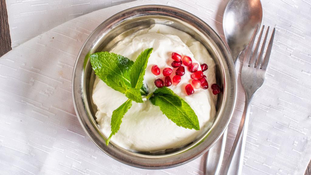 Persian Yogurt · Vegetarian. Whipped creamy plain yogurt mixed with cucumber, salt, garnished with mint served with pita bread.