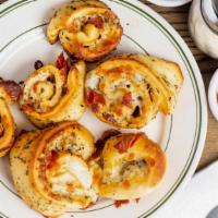 Pepperoni Bites · Fresh dough, brushed with a garlic and herb butter sauce, topped with a mozzarella and Monte...